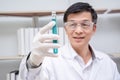 Asian professor scientist in protective gloves doing researching,testing tube,concept test samples antibiotic and future food used