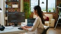Asian programmer seen typing code for a user interface design on dual monitors