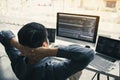 Asian programmers man are relaxing and looking at the code on the computer screen in the office Royalty Free Stock Photo