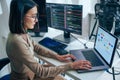 Asian prompt engineer develop coding app with software data sitting in front of computer monitor at office