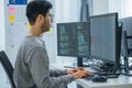 Asian prompt engineer developer coding app with software data sitting in front of computer monitor at office