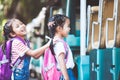 Asian pupil kids with backpack holding hand and going to school Royalty Free Stock Photo