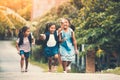 Asian pupil kids with backpack running Royalty Free Stock Photo