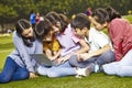Asian pupil using a laptop outdoors Royalty Free Stock Photo