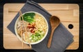 Asian ramen noodle pork bone based soup with pork chashu on cutting board background
