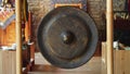 Asian religious metal gong to alert monks of prayer time - religion, tradition and lifestyle concept