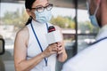 asian reporter in glasses and medical