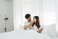 Asian Romantic couple in bed enjoying sensual foreplay Happy sensual young couple lying in bed together. Beautiful Royalty Free Stock Photo