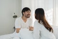 Asian Romantic couple in bed enjoying sensual foreplay Happy sensual young couple lying in bed together. Beautiful Royalty Free Stock Photo