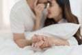 Asian Romantic couple in bed enjoying sensual foreplay Happy sensual young couple lying in bed together. Beautiful