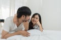 Asian Romantic couple in bed enjoying sensual foreplay Happy sensual young couple lying in bed together. Beautiful Royalty Free Stock Photo