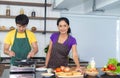 Asian romantic and lovely couple enjoy and happy cooking food in the kitchen