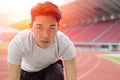 Asian runner men with focus eyes committed forward