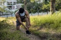 A asian runner pauses and massages his leg to alleviate pain from shin splints. Common running injury Royalty Free Stock Photo