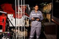 Asian 20s woman in grey uniform check count items in warehouse storage room. Maintenance Service