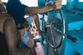 Asian Sailor is steering a helm while the boat transport the tourists across the sea to SAMED Island. Sea, travel and Royalty Free Stock Photo