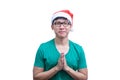 Asian Santa Claus man with eyeglasses and green shirt has plead Royalty Free Stock Photo