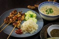 Asian satay meat skewers with rice, cucumber salad and peanut sa