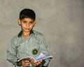 An Asian school boy holding a book Royalty Free Stock Photo