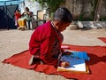 Asian school boy writing during common test at open area class in India January 2020 Royalty Free Stock Photo