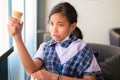 Girl have a hypersensitive teeth while eating ice-cream in the cafe after school Royalty Free Stock Photo