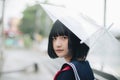 Asian school girl looking with umbrella in urban city Royalty Free Stock Photo