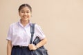 Asian School girl teen cute student in uniform happy smile with bag looking camera with space for text Royalty Free Stock Photo