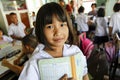 Asian School Girl in uniform hold a note book in her arm