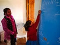 Asian school girl writing on chalkboard with teachers guidance in India January 2020 Royalty Free Stock Photo