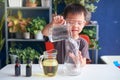 Asian school kid studying science, making DIY Lava Lamp Science Experiment, Kid-friendly fun and easy science experiments at home Royalty Free Stock Photo