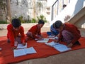 Asian school students writing during winter season in open area class in India January 2020