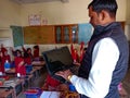 Asian school teacher giving training about laptop computer system at classroom in india January 2020 Royalty Free Stock Photo