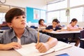 Asian schoolboy in elementary school class looking at board