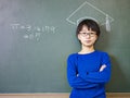 Asian schoolboy standing under a chalk-drawn doctoral cap