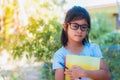 Asian schoolgirl holding books and pencils Royalty Free Stock Photo