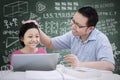 Asian schoolgirl praised by her teacher Royalty Free Stock Photo