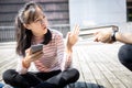 Asian schoolgirl sitting frustrated on floor and rejecting to reading books from her teacher at school,child girl canÃ¢â¬â¢t be