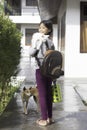 Asian schoolgirl was backpacking and carrying a lunch box with a white kitten