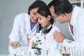 Asian scientist kid student and Indian teacher have fun with plant at biology class in school laboratory, do an experiment, using Royalty Free Stock Photo