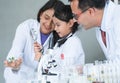 Asian scientist kid student and Indian teacher have fun with plant at biology class in school laboratory, do an experiment, using Royalty Free Stock Photo