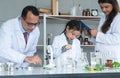 Asian scientist kid student and Indian teacher with plant at biology class in school laboratory, do an experiment, learning, Royalty Free Stock Photo