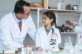 Asian scientist kid student and Indian teacher with plant at biology class in school laboratory, learning, teaching child girl to Royalty Free Stock Photo