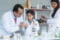 Asian scientist kid student and Indian teacher with plant at biology class in school laboratory, learning, teaching child girl to Royalty Free Stock Photo
