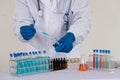 Asian scientists conducting laboratory experiments. The pipette lowers the sample into a close-up test tube. Royalty Free Stock Photo