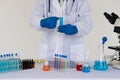 Asian scientists conducting laboratory experiments. The pipette lowers the sample into a close-up test tube. Royalty Free Stock Photo