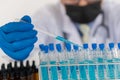 Asian scientists conducting laboratory experiments. The pipette lowers the sample into a close-up test tube. Royalty Free Stock Photo