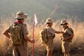 Asian Scout Leader watches as two Scouts in the team inspect each other`s attire before making the long journey to the Scout camp