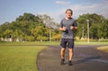 Asian senile man jogging in the nature atmosphere in the morning sunshine