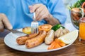 Asian senio woman patient eating breakfast with vegetable healthy food while sitting and hungry on bed in hospital