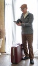 Asian senior business man with vintage luggage and smart phone w Royalty Free Stock Photo